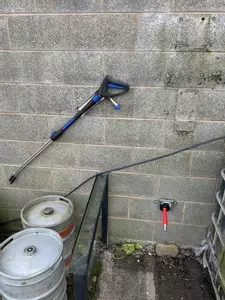 Outdoor connection point and pressure washer trigger gun installed for external cleaning at a Twycross farm.